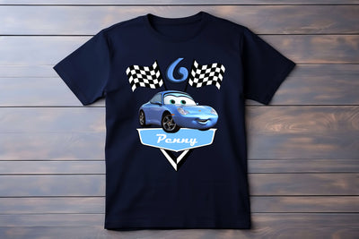 Black t-shirt with a blue car graphic and text on a wooden surface