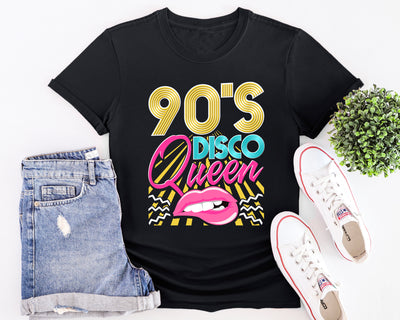 Flat lay of 90’s gold Disco Queen t-shirt with bold retro lettering and pink disco theme design