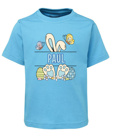 Blue t-shirt with cartoon design and name 'Paul' on a white background