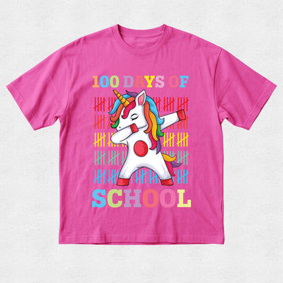 Pink t-shirt with a unicorn graphic and '100 Days of School' text on a light gray background