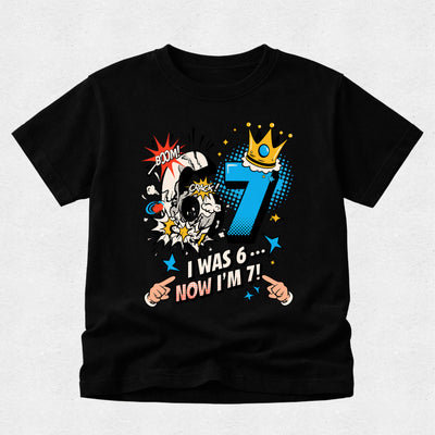 Black personalised 7th birthday t-shirt with comic-style "I Was 6... Now I'm 7!" design for boys.