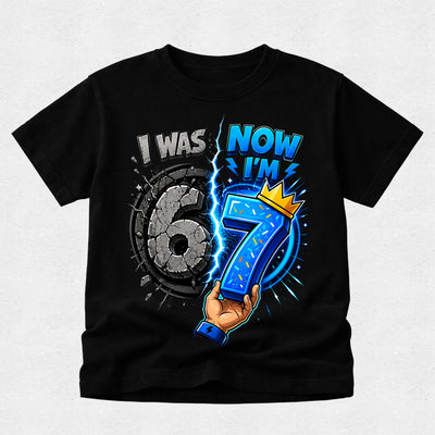 Black t-shirt with a graphic of a hand holding the number 7, celebrating turning 7 years old.