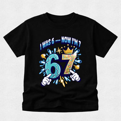 Black boys 7th birthday t-shirt with colourful cartoon number design reading "I Was 6 Now I'm 7".