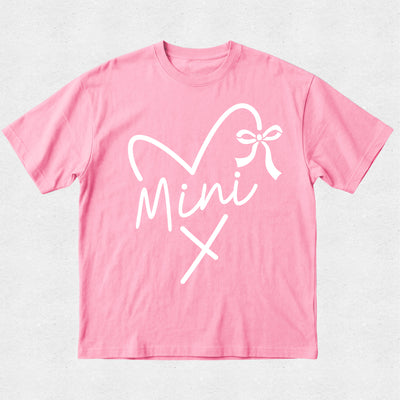 Pink t-shirt with white graphic design on a light gray background