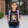Girl wearing a black t-shirt with a unicorn graphic and '100 Days of School' text, standing outside a building.