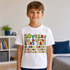 A smiling young boy wearing a white graphic t-shirt with colorful text celebrating 10 years, standing in a brightly lit bedroom.