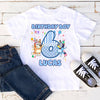 White t-shirt with 'Birthday Boy 6 Lucas' design, paired with jeans and black sneakers on a wooden surface.