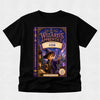 A black short-sleeve t-shirt with a large graphic print of the book cover for 'The Wizard's Apprentice: Starling Con' on the front, displayed against a light gray textured background.