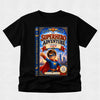 A black short-sleeve crewneck t-shirt featuring a large graphic print of a children's book cover titled 'The Superhero Adventure Starring Aaron'. The graphic shows a cartoon boy superhero in a blue and red costume with a city skyline in the background.