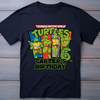 Black t-shirt with Teenage Mutant Ninja Turtles graphic and personalized text on a wooden background
