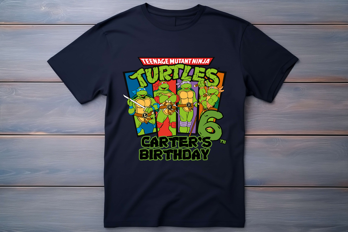 Black t-shirt with Teenage Mutant Ninja Turtles graphic and personalized text on a wooden background