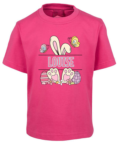 Pink t-shirt with Easter-themed graphics and the name 'Louise' on a white background