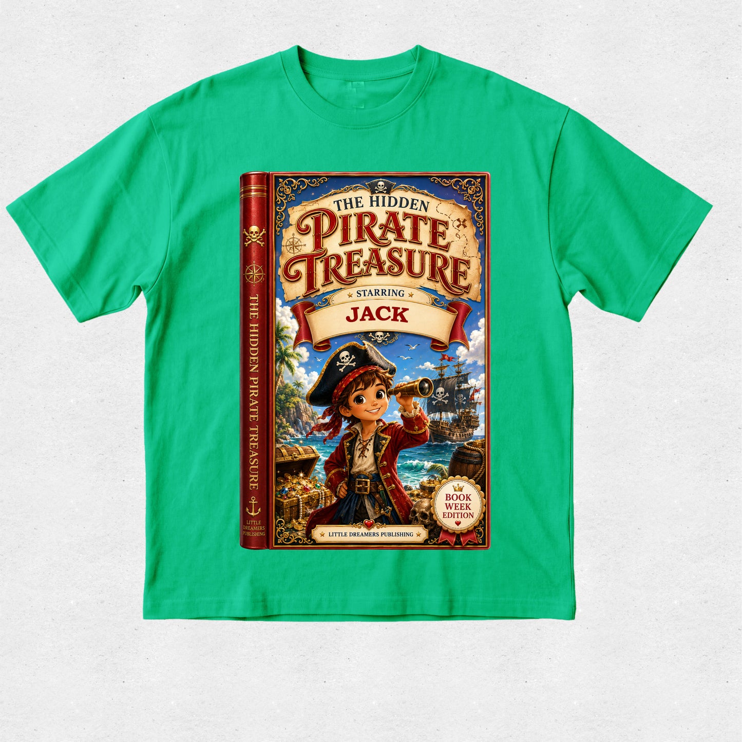 A bright green short-sleeve crewneck t-shirt featuring a large graphic print of the children's book 'The Hidden Pirate Treasure: Starring Jack' on the front, laid flat against a light gray textured background.