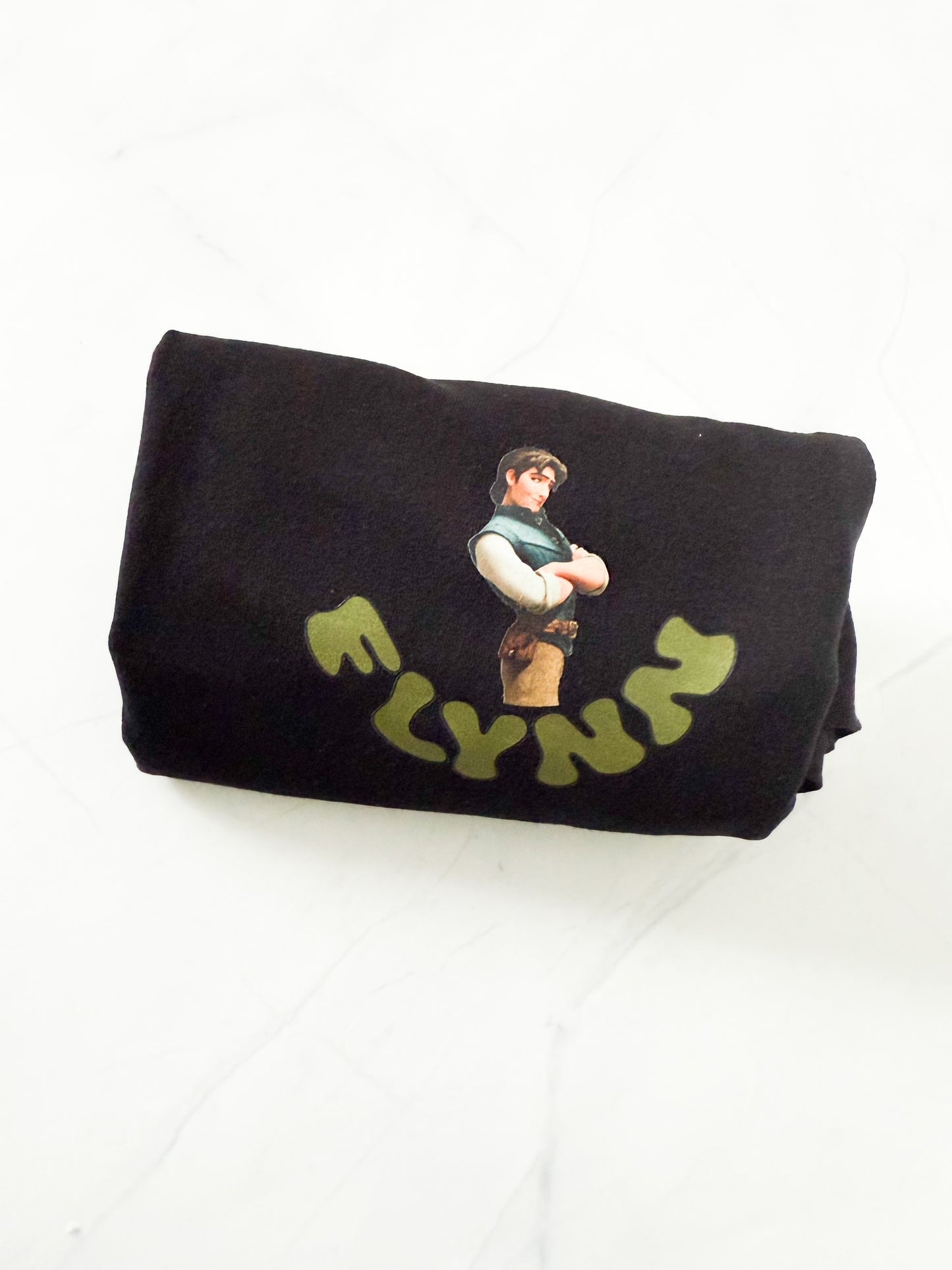 Black t-shirt with a graphic design and 'FLYNN' text on a white background