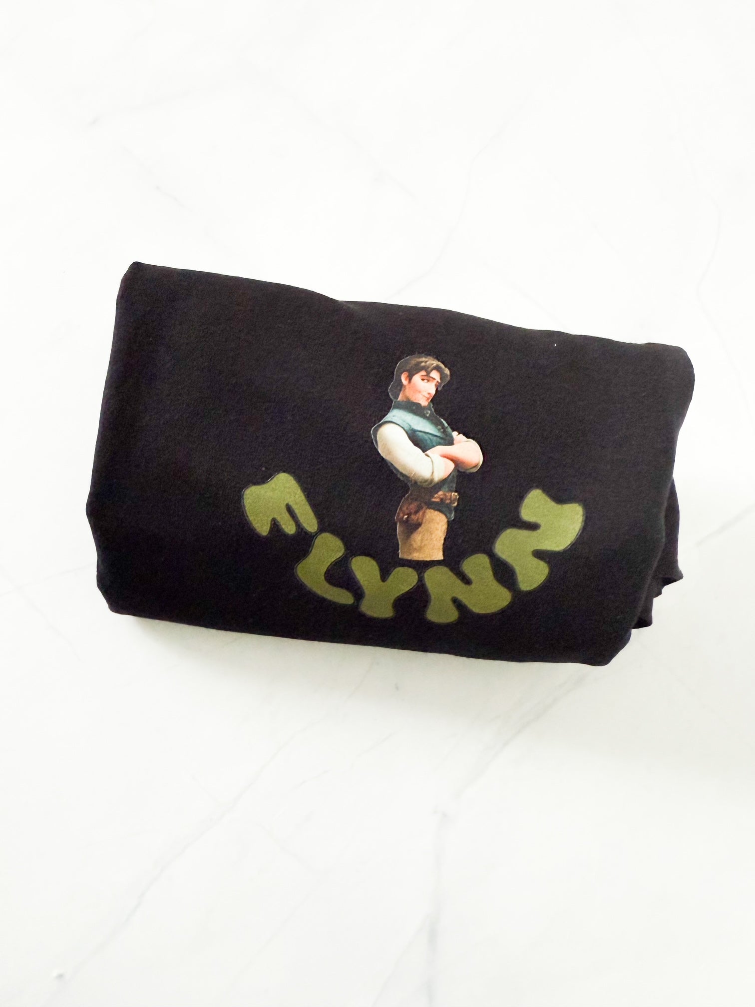 Black t-shirt with a graphic design and 'FLYNN' text on a white background