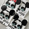 flat lay Castle Reflections T-shirt with Mickey & Minnie wearing sunglasses showing castle reflection
