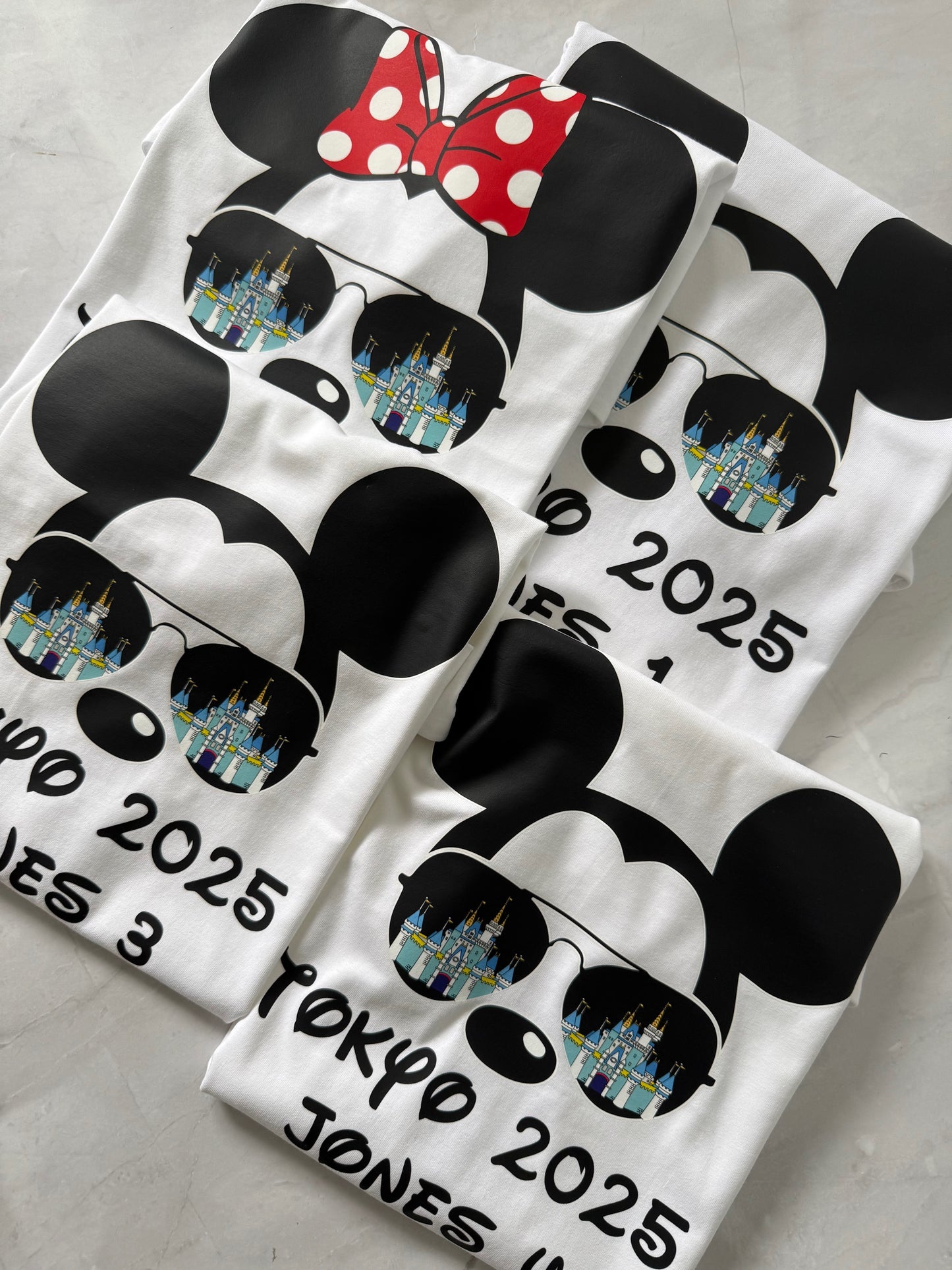 flat lay Castle Reflections T-shirt with Mickey & Minnie wearing sunglasses showing castle reflection