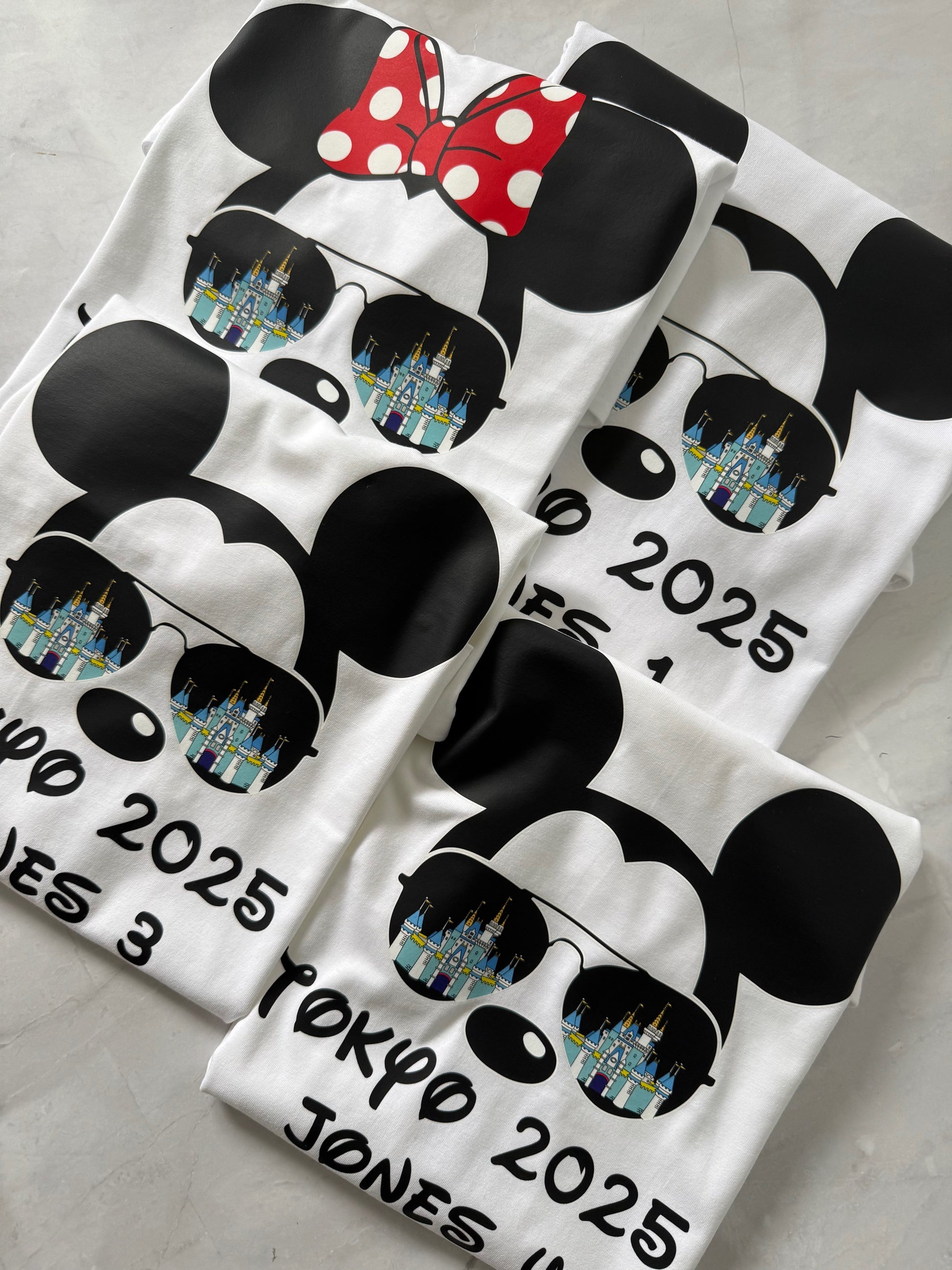 flat lay Castle Reflections T-shirt with Mickey & Minnie wearing sunglasses showing castle reflection