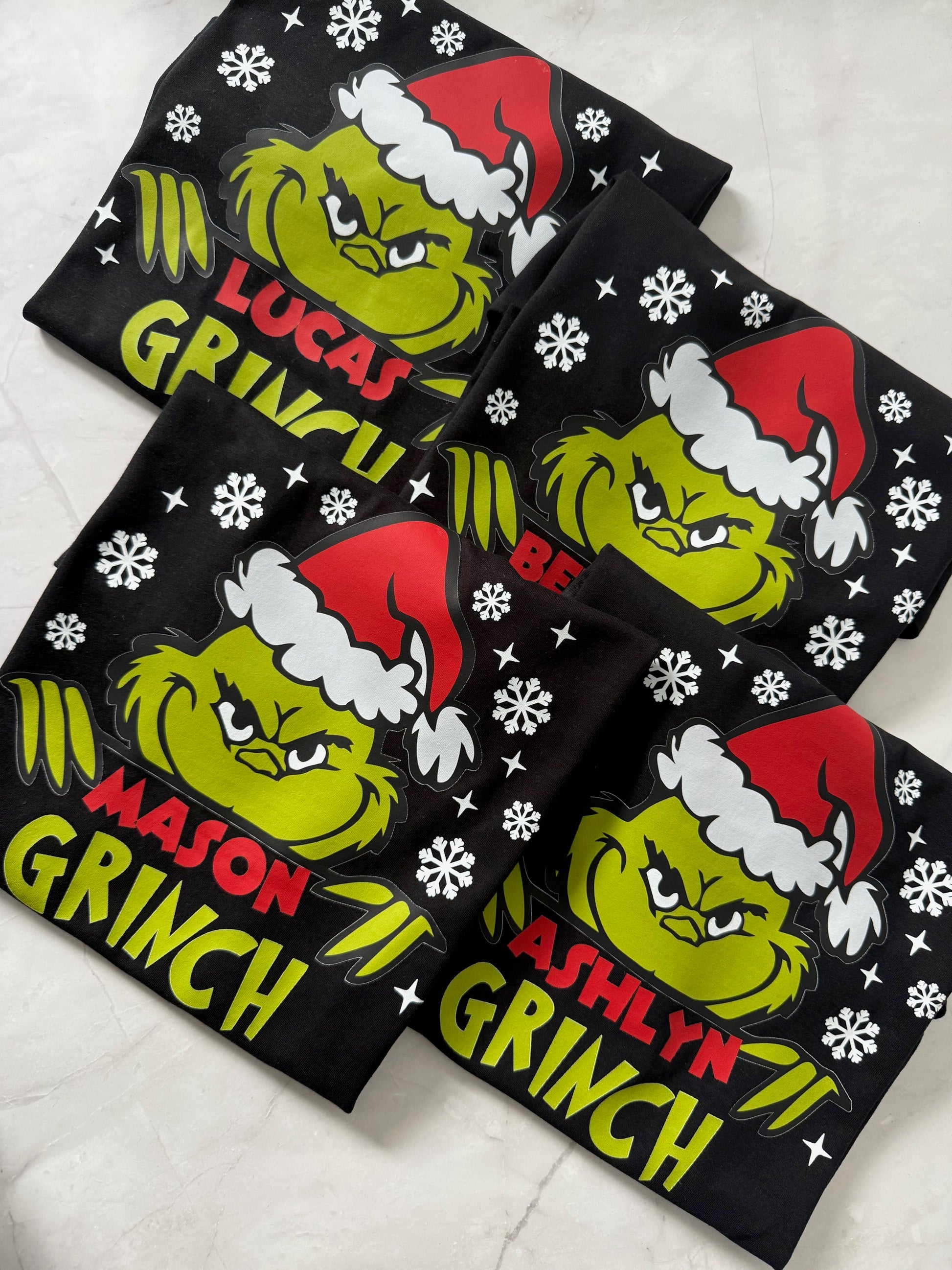 Personalised festive Grinch t-shirt with custom text under design