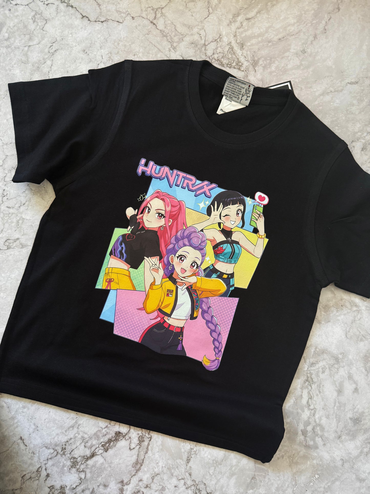 Huntrix streetwear shirt with bold anime girl illustrations and graphic lettering