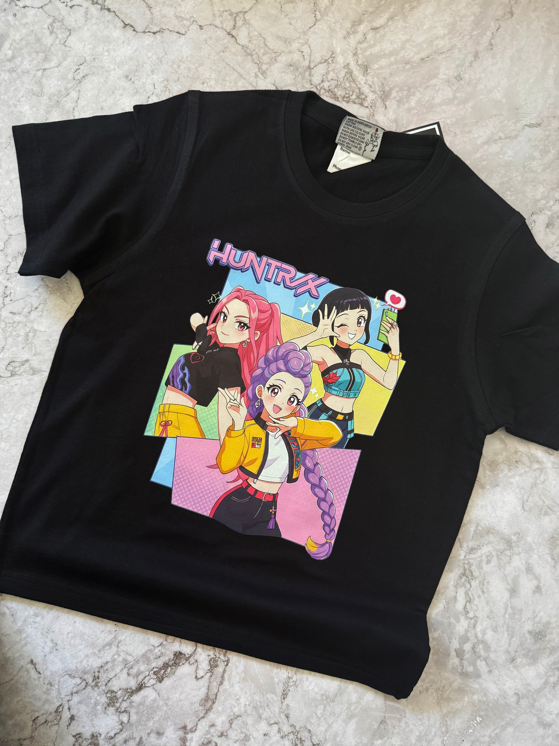 Huntrix streetwear shirt with bold anime girl illustrations and graphic lettering