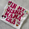 Flat lay of Disney Mama Era shirt styled with jeans and mouse ears for a park-ready outfit