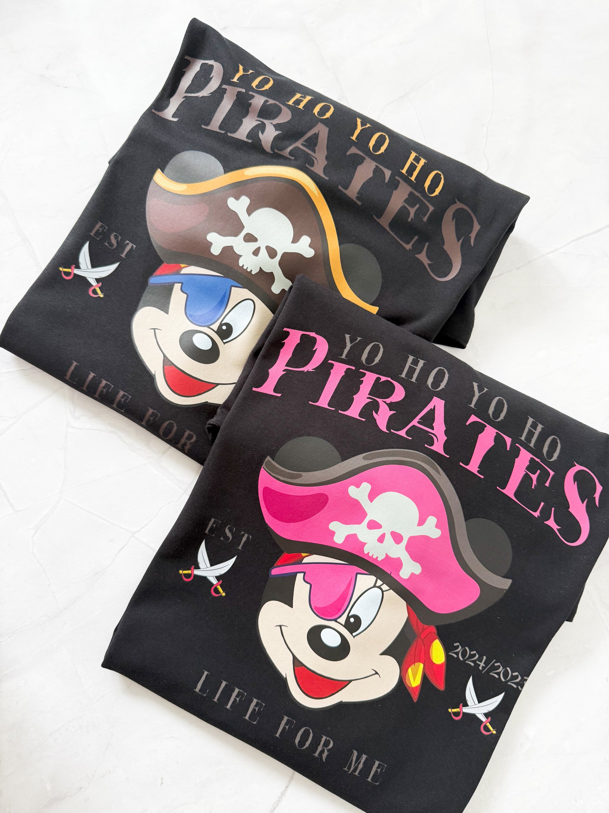 Two black pirate-themed shirts with mickey and minnie yo ho yo ho