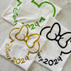 Three white t-shirts with Disney-themed designs 