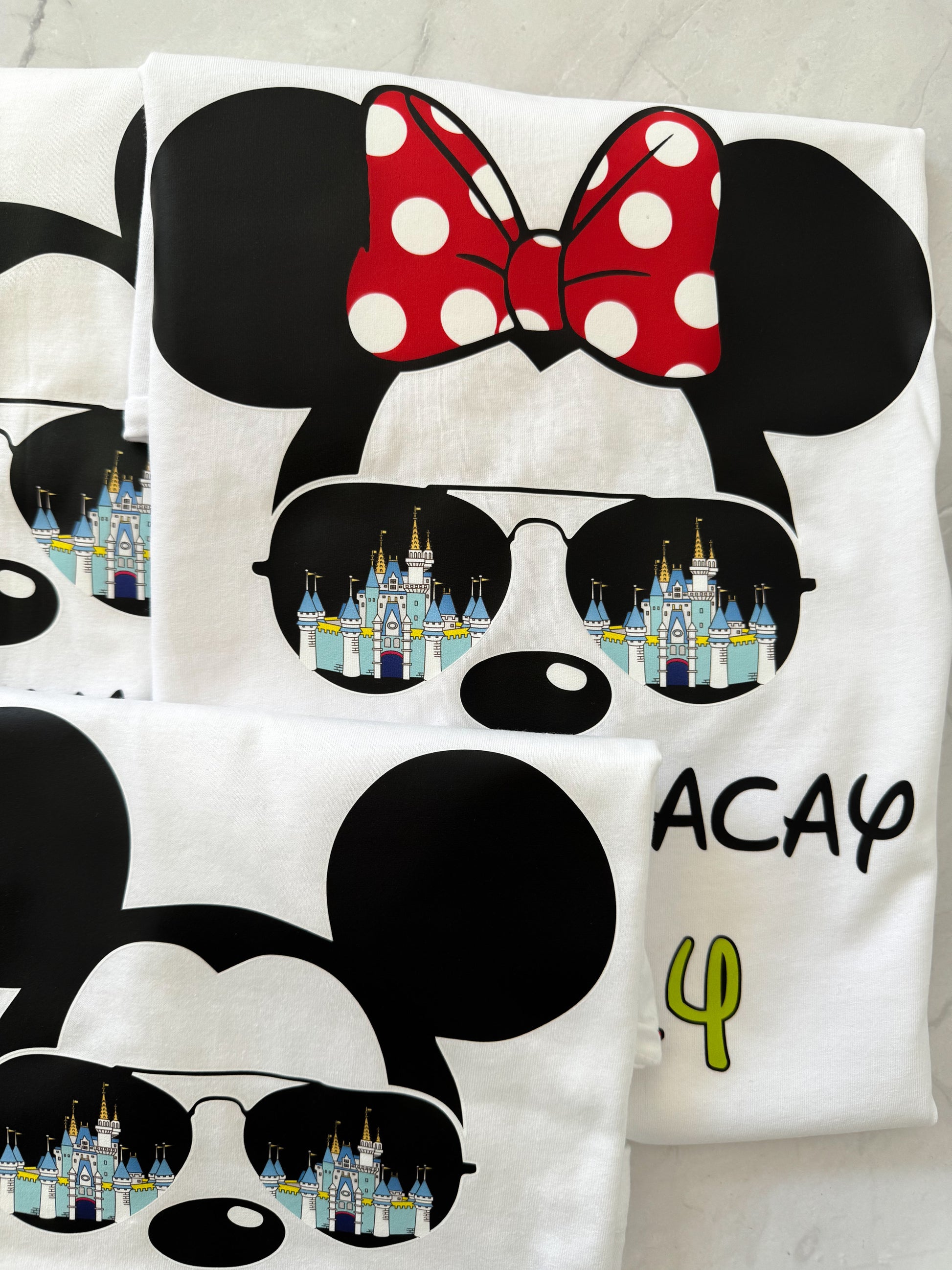 T-shirt with Minnie Mouse design, sunglasses with castle reflection, and 'VACAY' text.