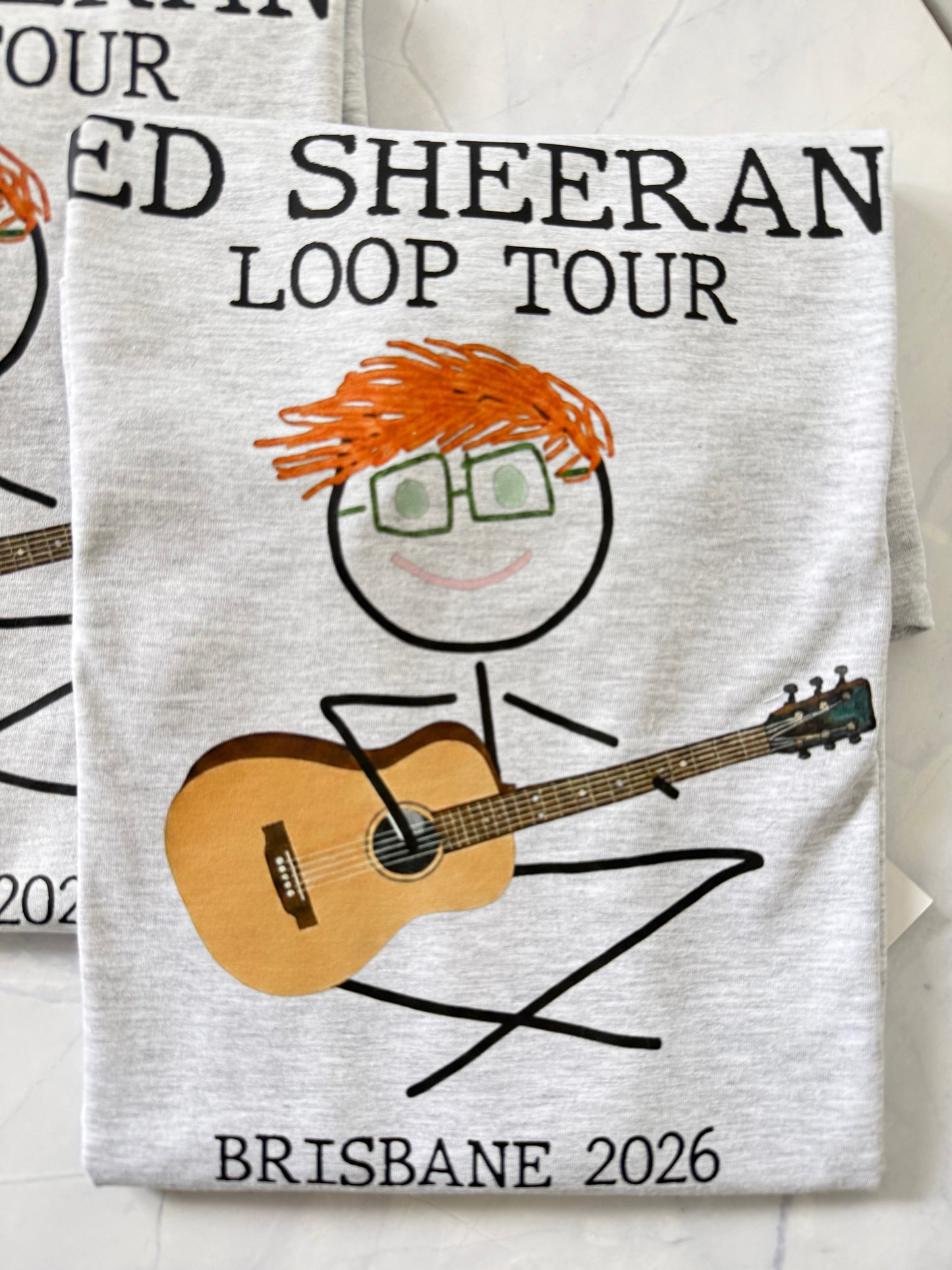Promotional shirt for Ed Sheeran Loop Tour with guitar and logo design on a white background