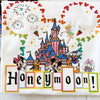 Disney-themed towel with cartoon characters and 'Honeymoon!' text on a white background