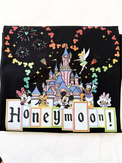 Close-up of romantic castle artwork and magical lettering on Disney-inspired honeymoon shirt

