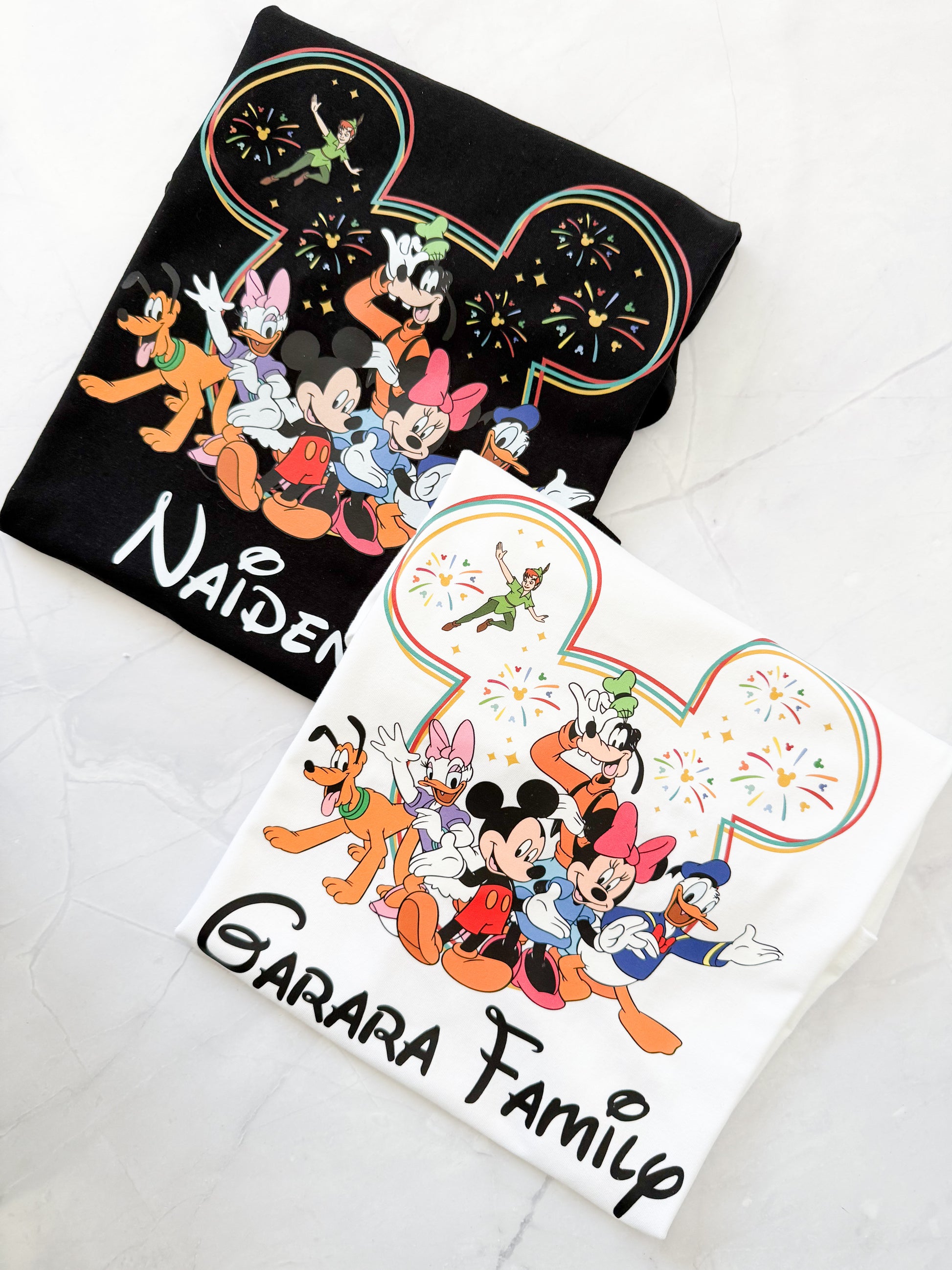 Two tshirts with cartoon character designs and text on a light gray background