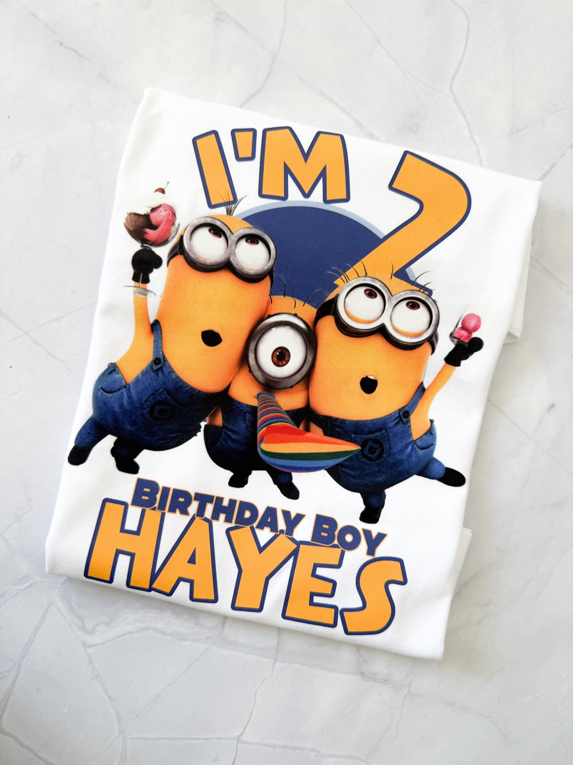 Child wearing Minions birthday t-shirt at party