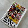 Towel with Disney characters and 'Disney World Tour' text on a textured surface