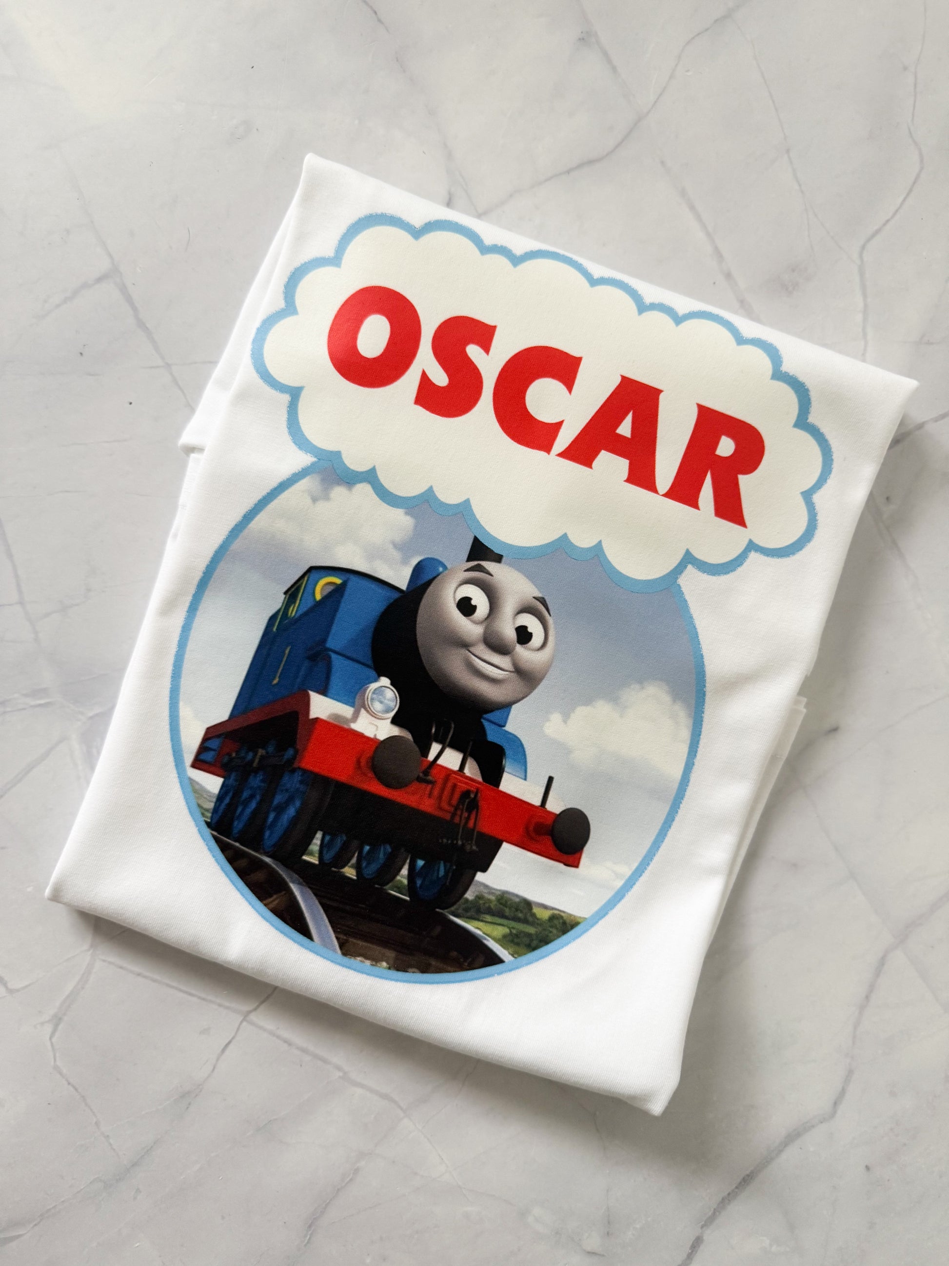 Close-up of personalised text on Thomas themed birthday shirt