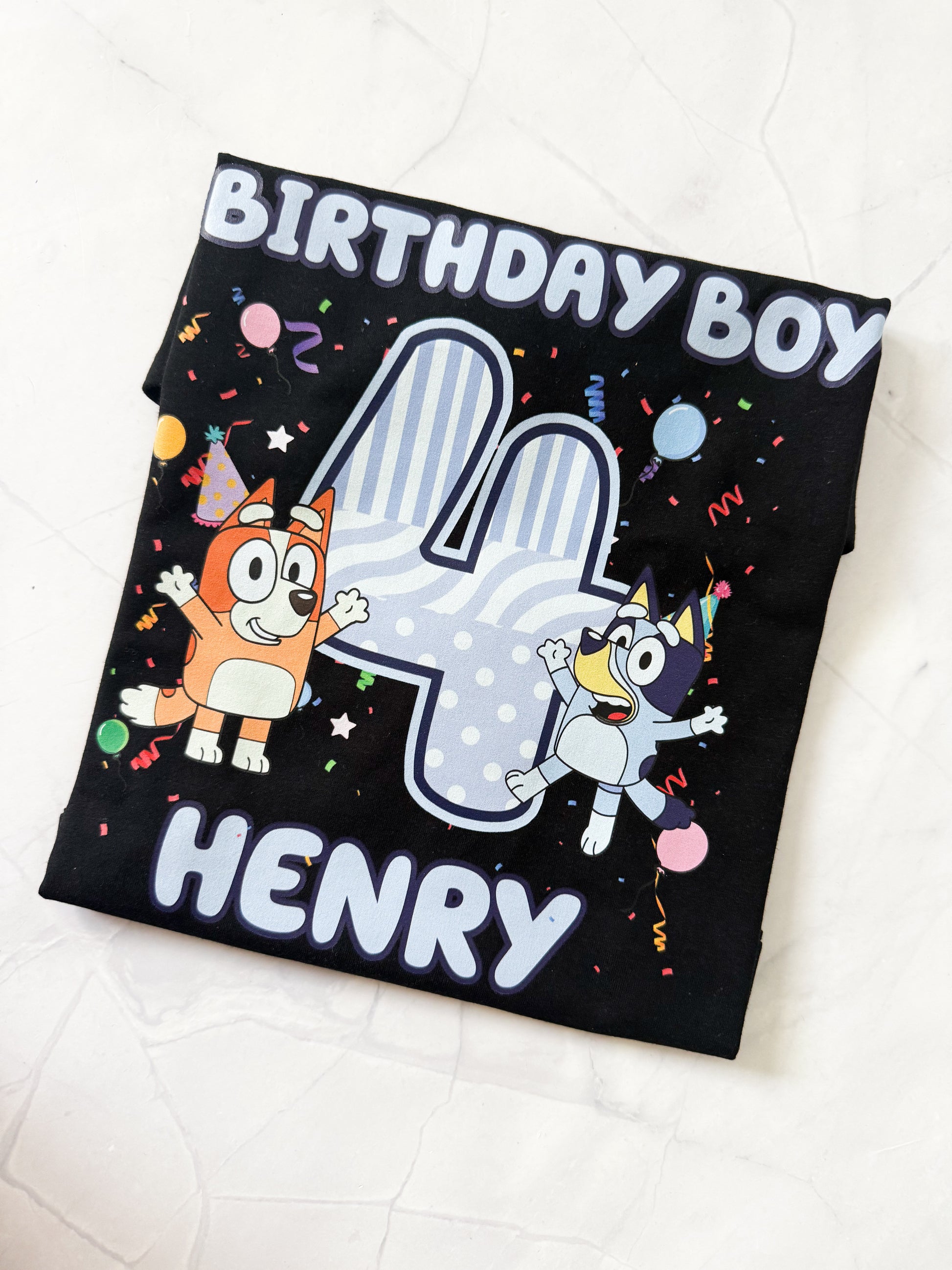 Black t-shirt with cartoon characters and 'Birthday Boy Henry' text on a white background