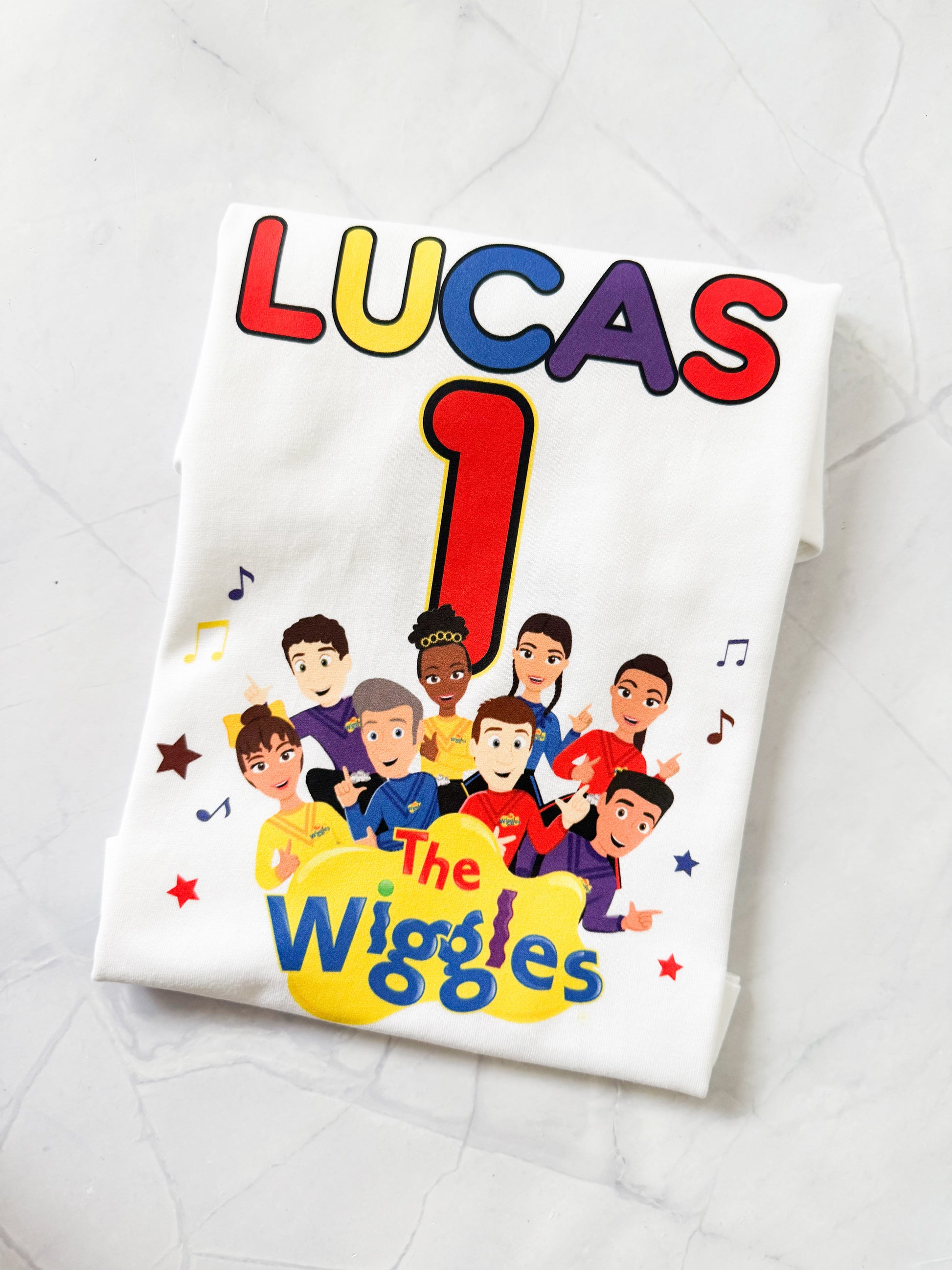 Close-up of Wiggles style birthday design with character colours and personalised name