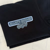 A folded black t-shirt on a light marble surface, featuring a graphic print on the front with a blue and white outlined badge that reads 'ALLAN'S GARAGE' above a silver line-art vehicle illustration.