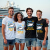 Four friends wearing matching cruise-themed t-shirts in front of a cruise ship.