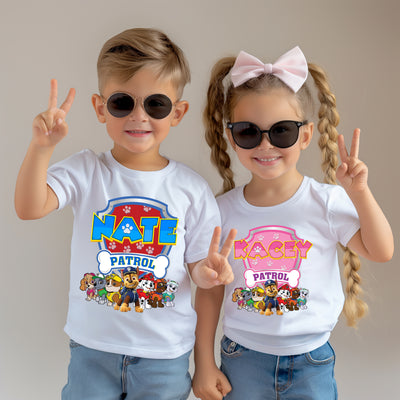 Two children wearing 'Nate Patrol' and 'Rachy Patrol' t-shirts with cartoon characters on a plain background.