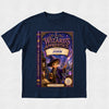 A navy blue short-sleeve t-shirt with a large graphic print of a children's book cover titled 'The Wizard's Apprentice: Starring John' on the front, displayed against a light textured background.