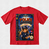 A red short-sleeve crewneck t-shirt featuring a large graphic print of a children's book cover titled 'The Police Adventure: Starting Carolyn'. The graphic depicts a cartoon girl in a police uniform saluting in front of a city skyline with flashing lights, with the book spine visible on the left side of the print.