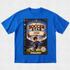 A royal blue short-sleeve t-shirt with a large graphic print of a children's book cover titled 'The Soccer Star Starring John' on the front, displayed flat against a light gray textured background.