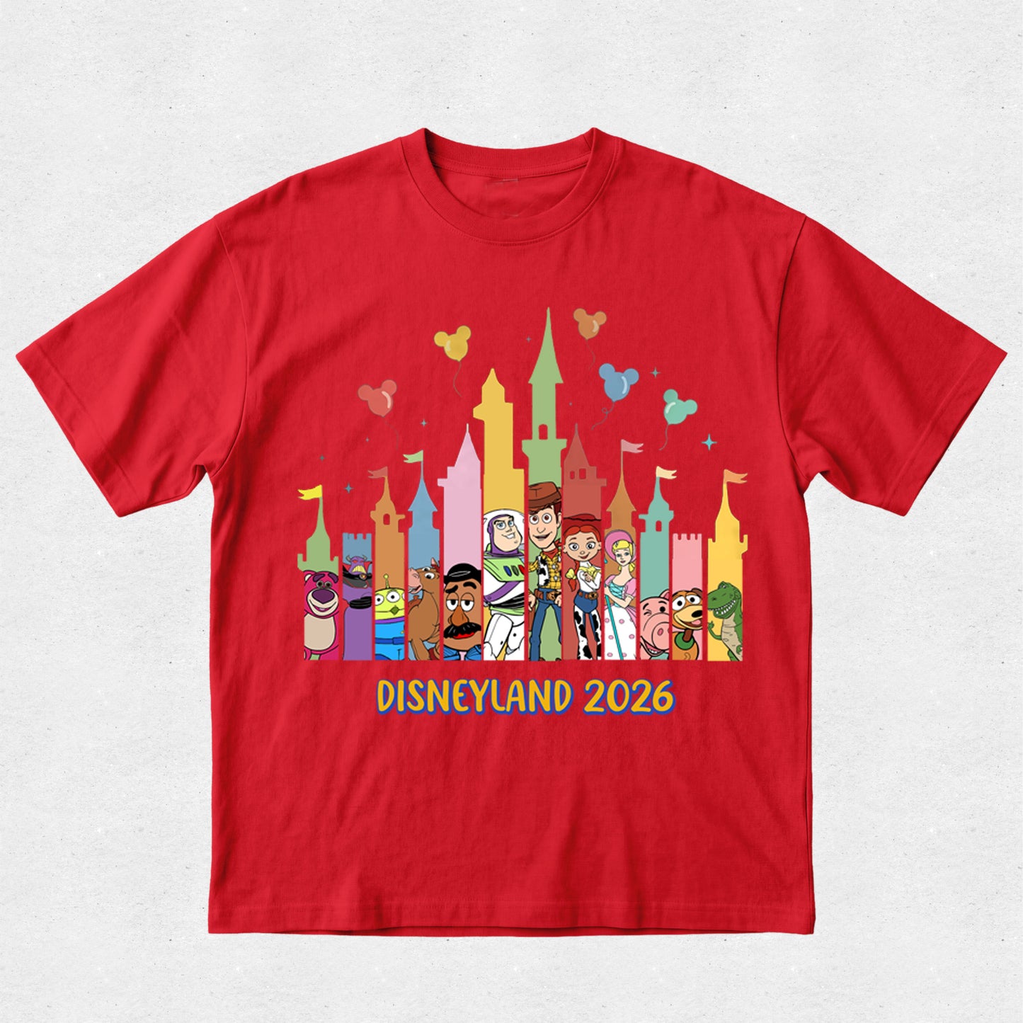 Red t-shirt with colorful Disney characters and 'Disneyland 2026' text on a white background