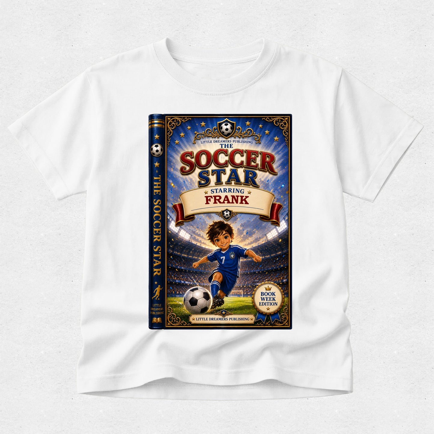 A white short-sleeve crewneck t-shirt featuring a large graphic print of the book cover for 'The Soccer Star Starring Frank' on the front, displayed against a light gray textured background.
