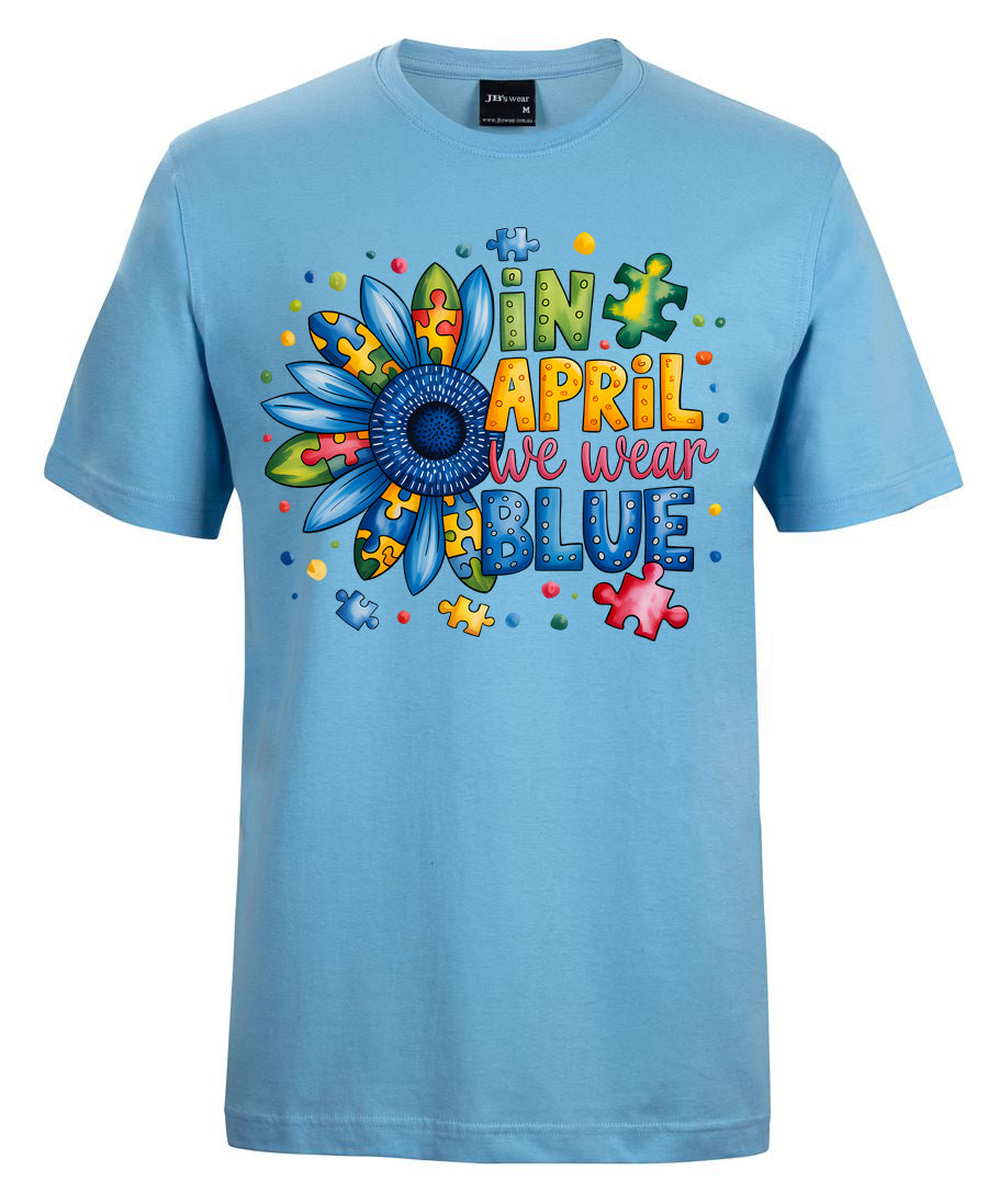 Light blue t-shirt with colorful flower design and text on a white background