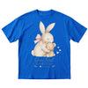 Blue t-shirt with a bunny and teddy bear graphic and text on a white background