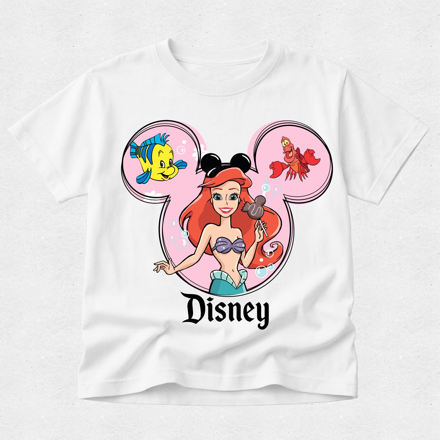 White t-shirt with Disney character design featuring Ariel, Flounder, and Sebastian.