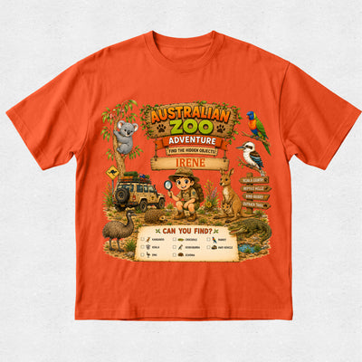 A bright orange short-sleeve t-shirt with a large, colorful 'Australian Zoo Adventure' graphic on the front, featuring cartoon animals and safari vehicles on a light gray textured background.
